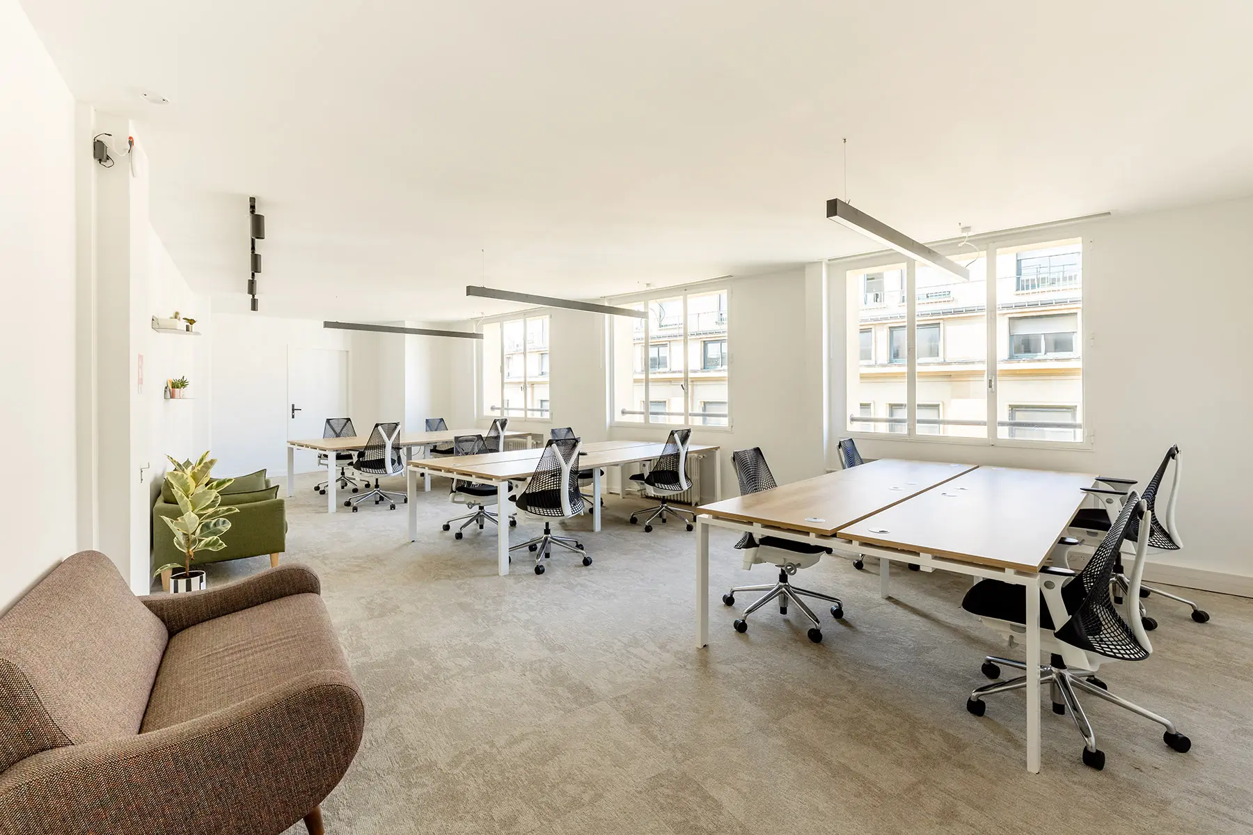 Espace de travail, quartier les Halles, flexible avec des bureaux modulables, des chaises ergonomiques, et des séparateurs amovibles, permettant différentes configurations pour le travail collaboratif ou individuel.