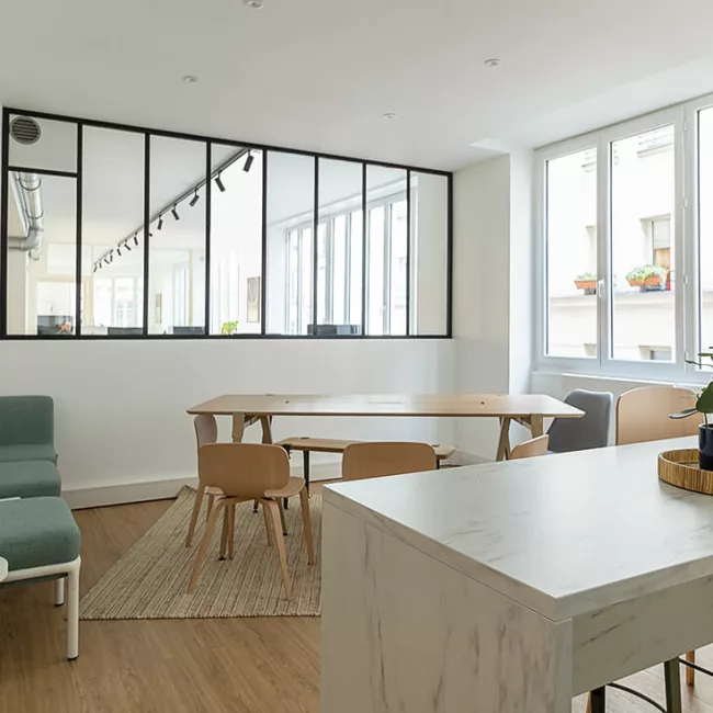 Espace de travail, quartier Sentier, flexible avec des bureaux modulables, des chaises ergonomiques, et des séparateurs amovibles, permettant différentes configurations pour le travail collaboratif ou individuel.